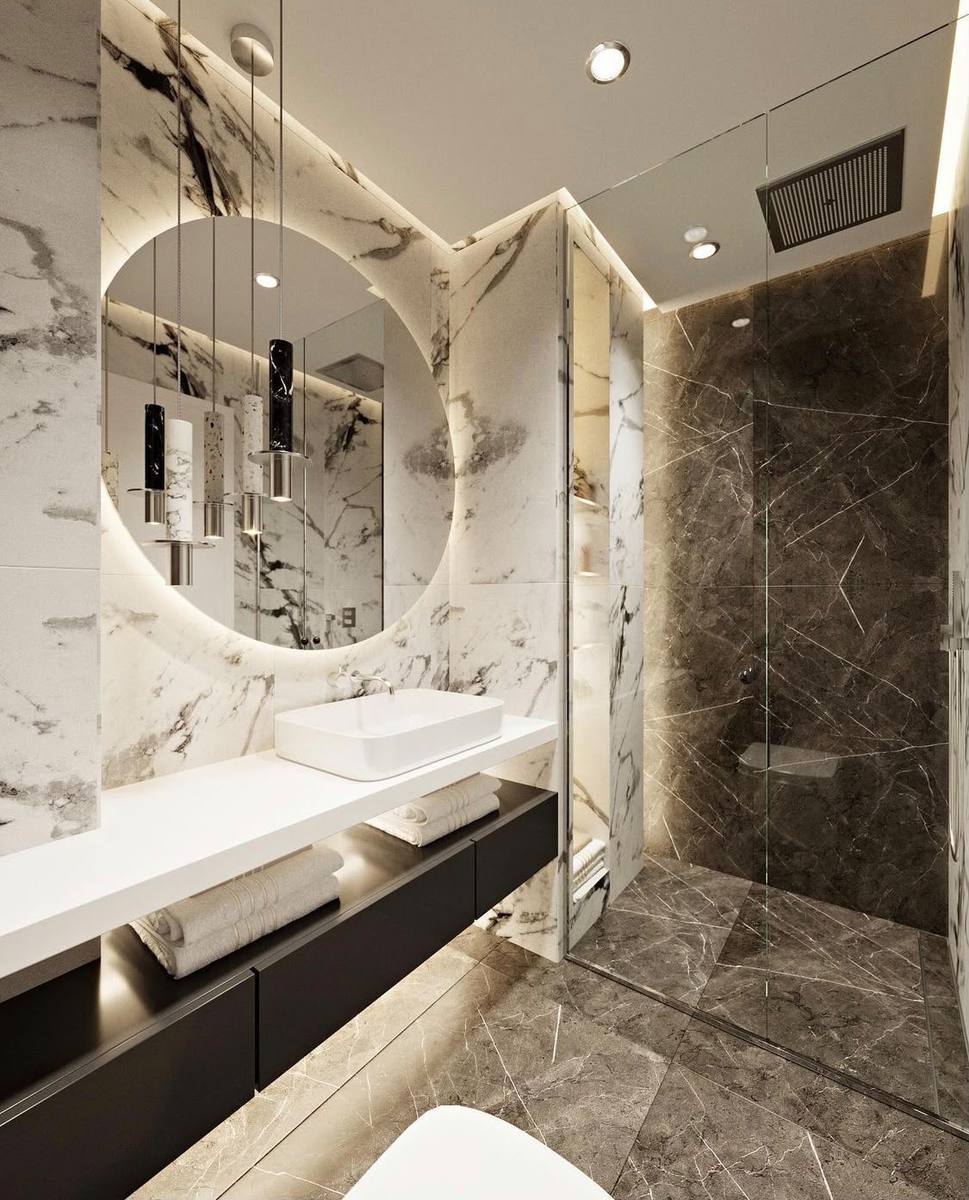 Completed bathroom renovation by INNA GROUP — frameless shower and stone tiling.